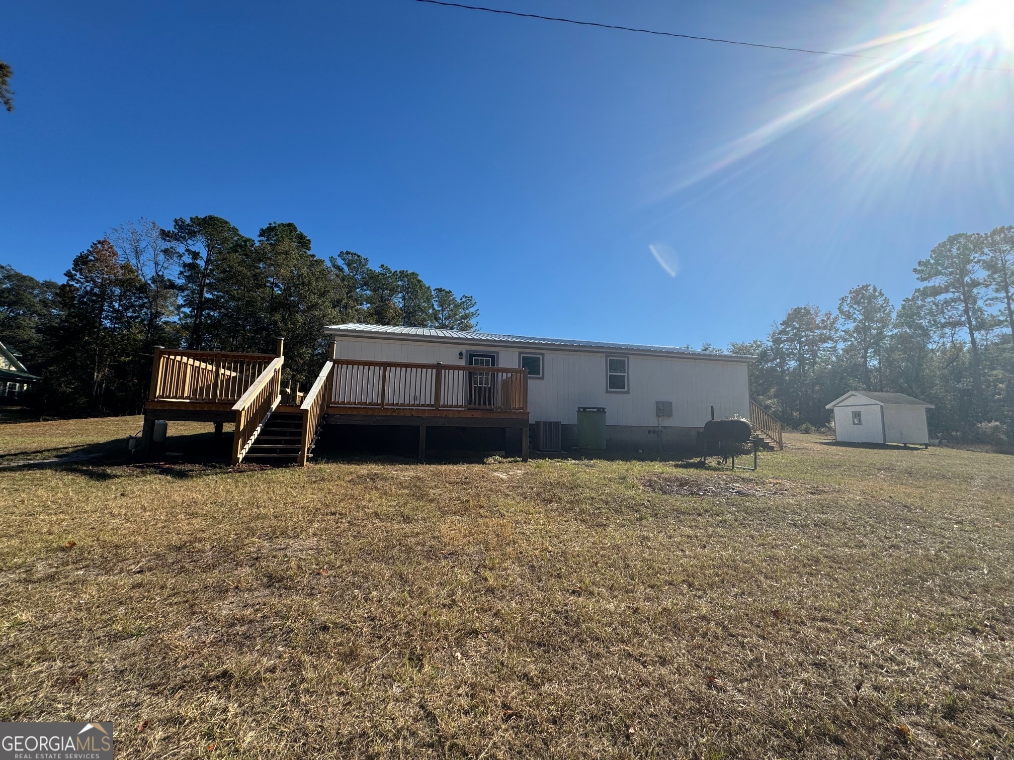 2199 Tom Crawford Road Hilliard, FL 32046 - Photo 3 of 18 a backyard of a house with table and chairs