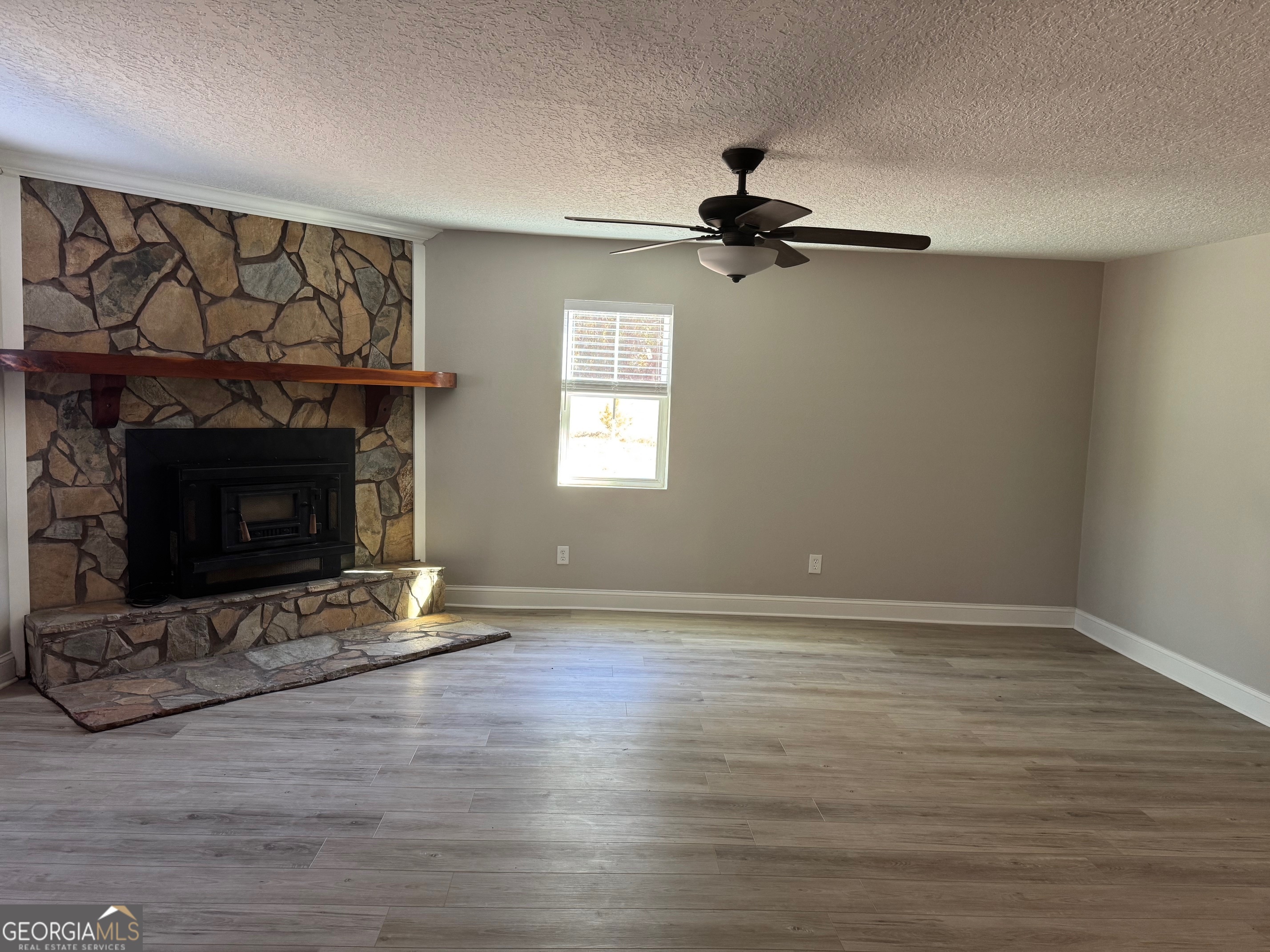2199 Tom Crawford Road Hilliard, FL 32046 - Photo 10 of 18 a view of empty room with wooden floor and fireplace