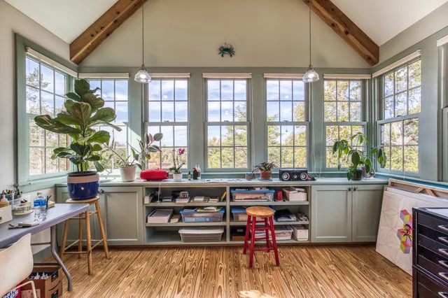 a living room filled with furniture windows and a table