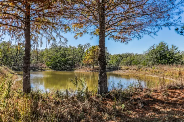 a view of a lake with houses in the back