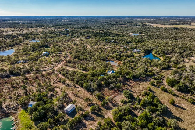 an aerial view of a houses with a yard