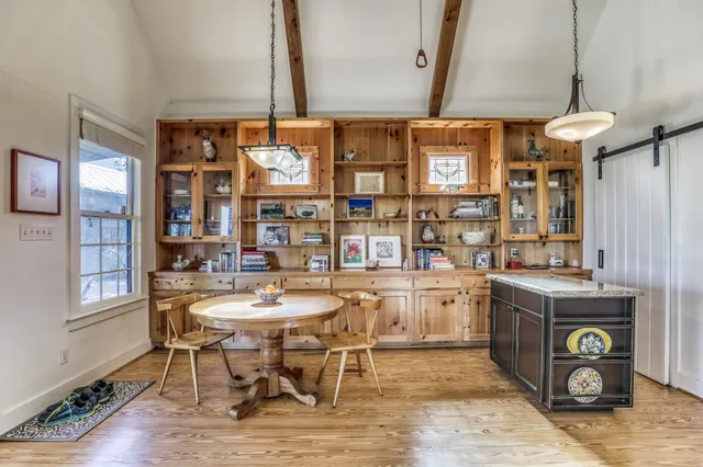 a kitchen with a table and chairs in it