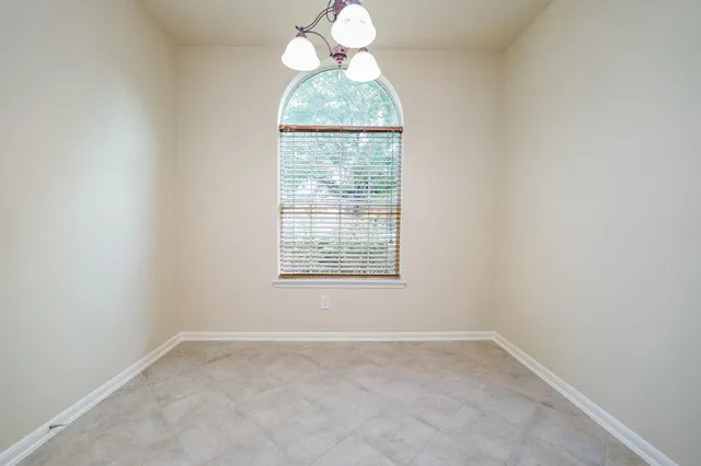 a kitchen with stainless steel appliances granite countertop a refrigerator a sink dishwasher a oven with a dining table and chairs