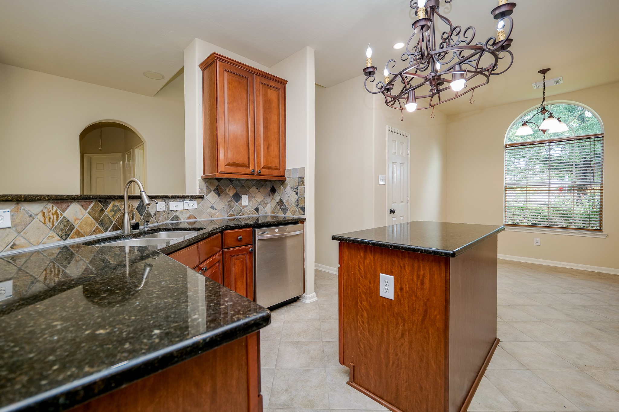 20127 Jasper Oaks Drive Cypress, TX 77433 - Photo 12 of 32 a kitchen with a sink a counter top space cabinets and stainless steel appliances
