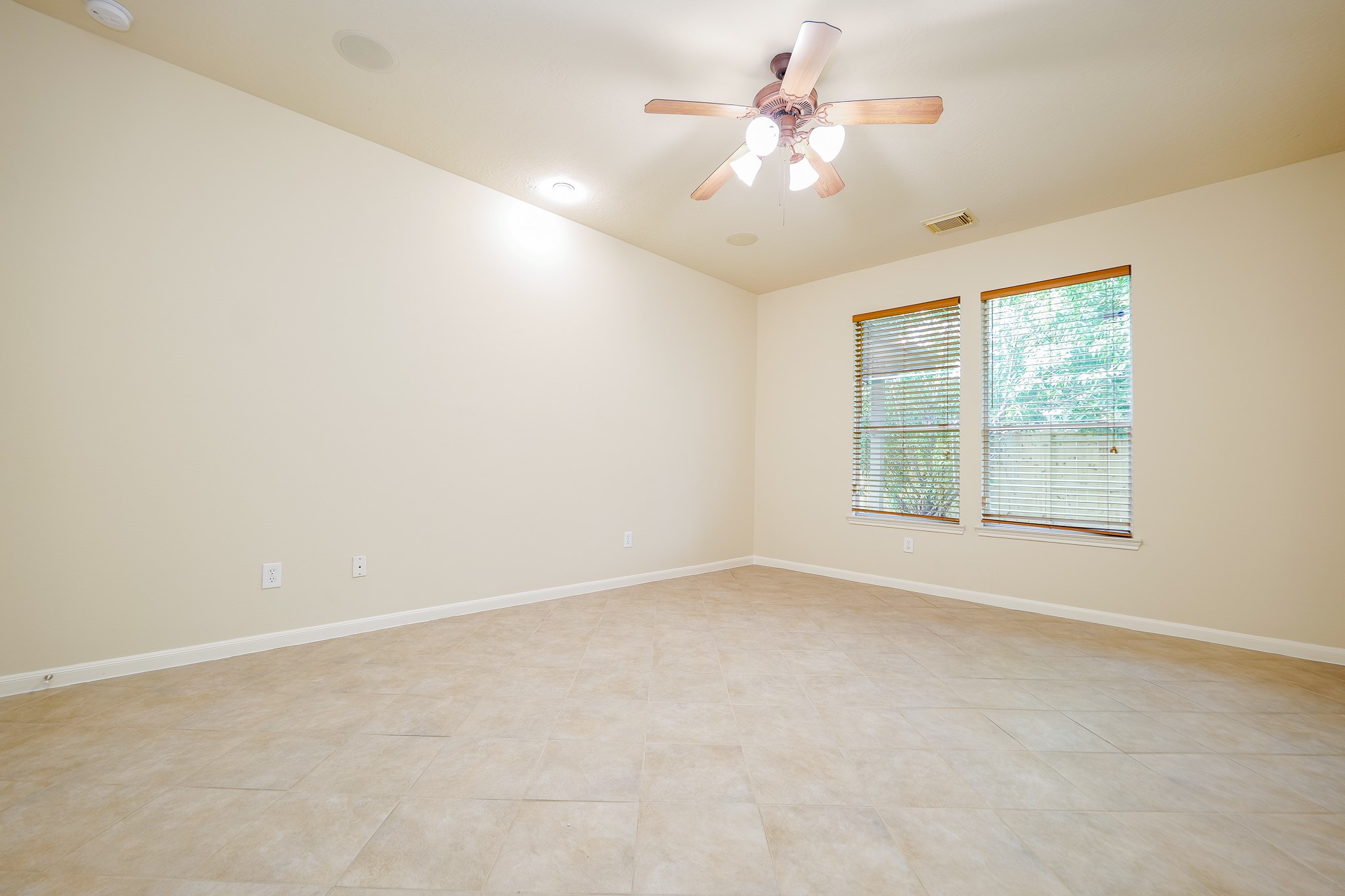 20127 Jasper Oaks Drive Cypress, TX 77433 - Photo 16 of 32 an empty room with a window and a ceiling fan