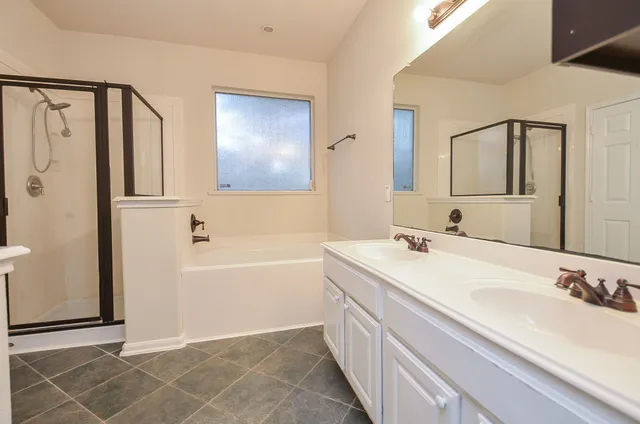 an empty room with a window and a ceiling fan