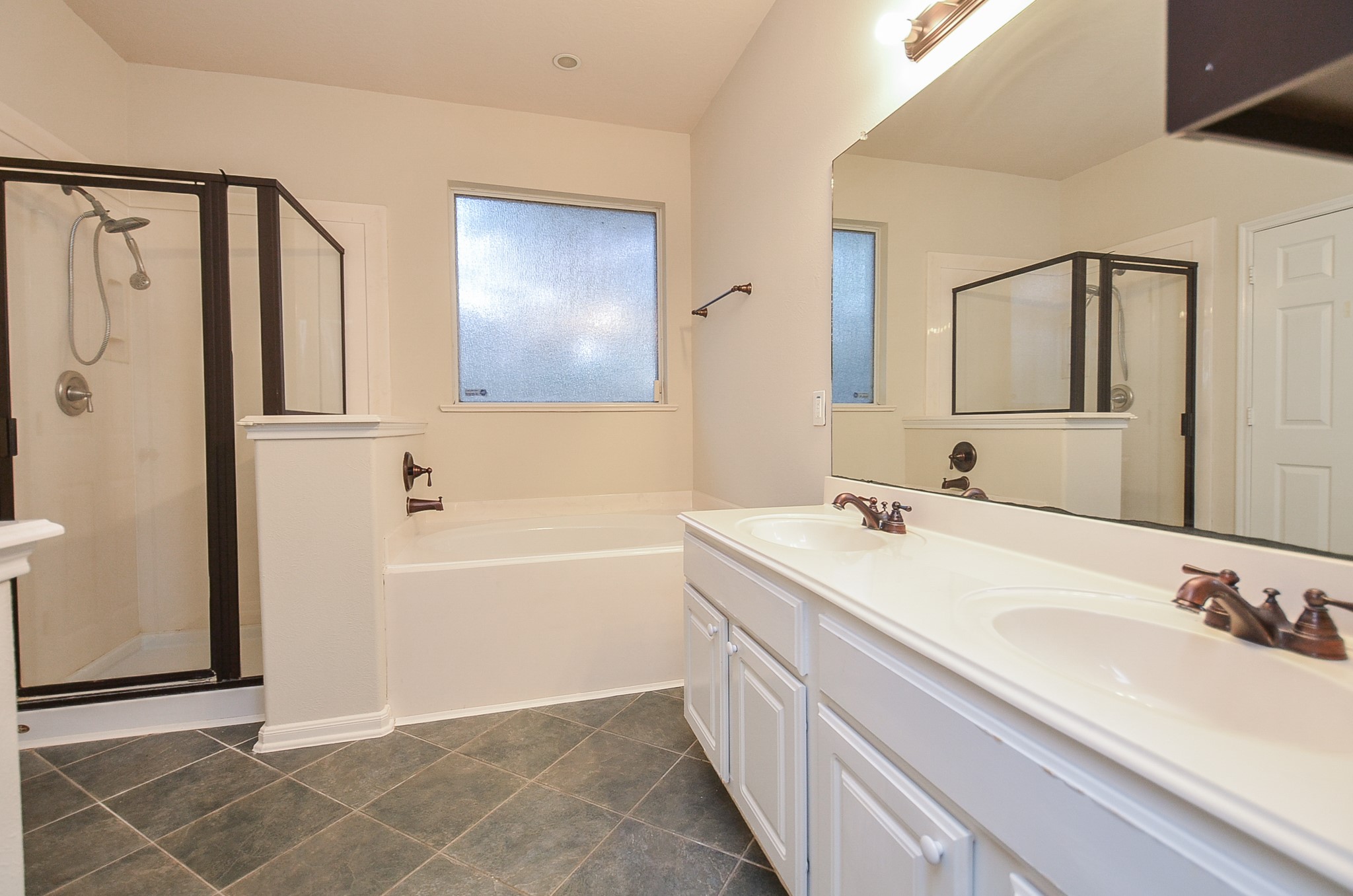 20127 Jasper Oaks Drive Cypress, TX 77433 - Photo 17 of 32 a bathroom with a tub sink and mirror