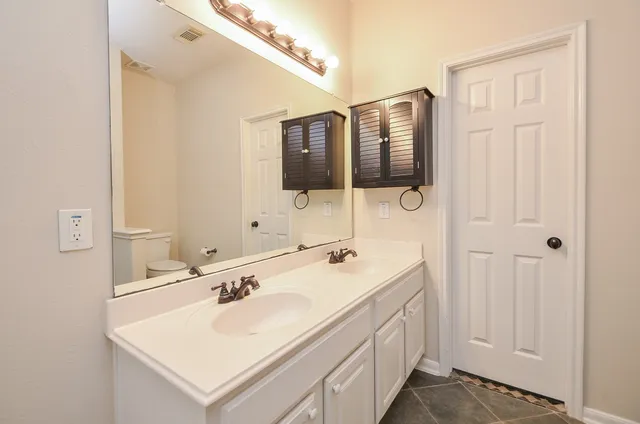 a bathroom with a tub sink and mirror
