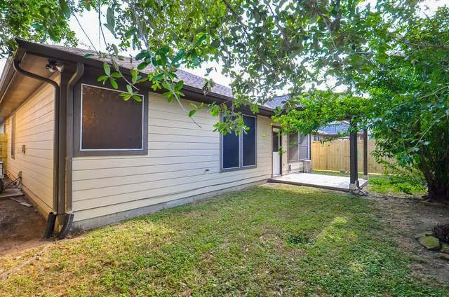 a view of a porch with a table and chairs
