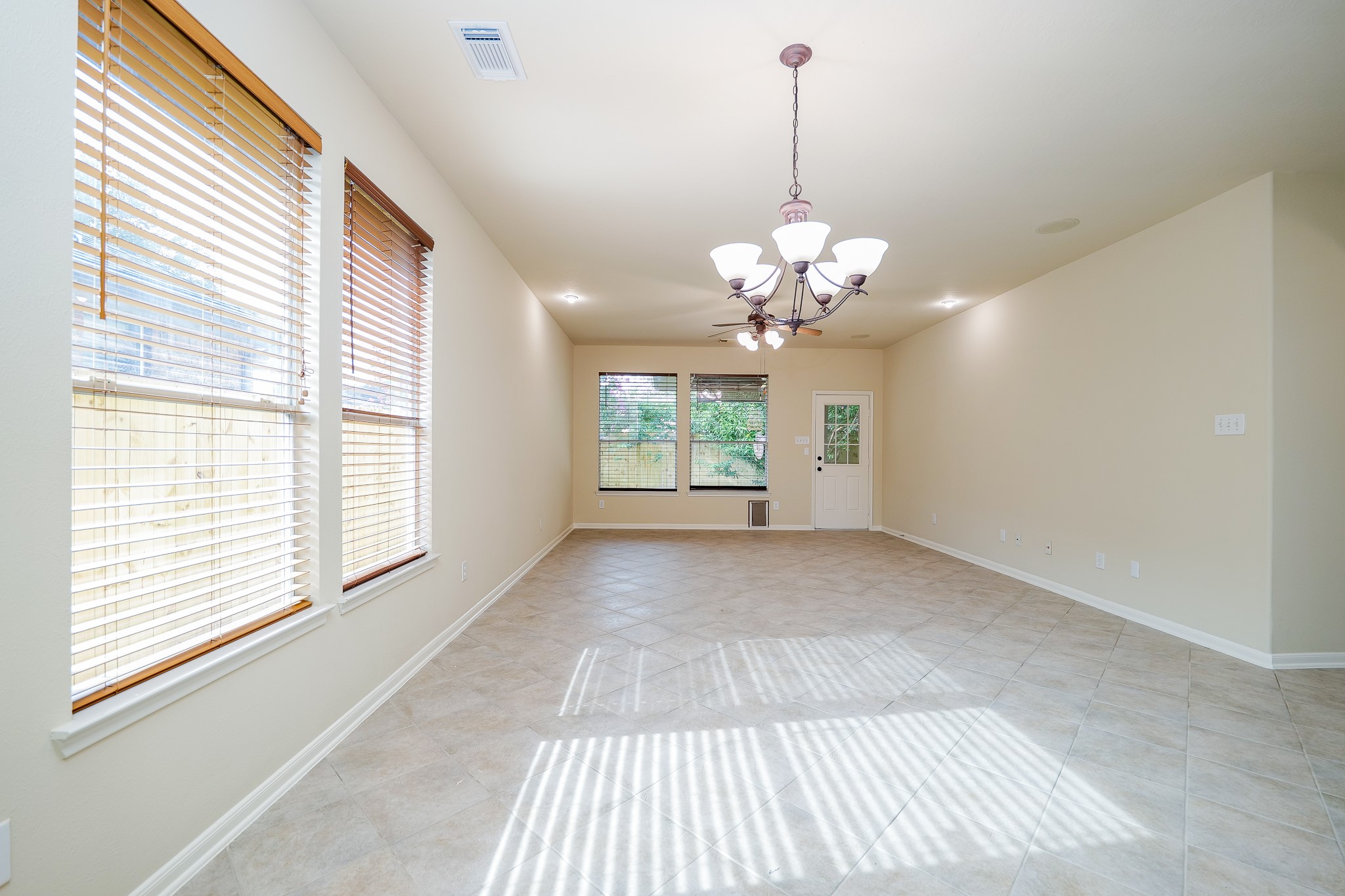 20127 Jasper Oaks Drive Cypress, TX 77433 - Photo 7 of 32 a view of a room with windows and chandelier