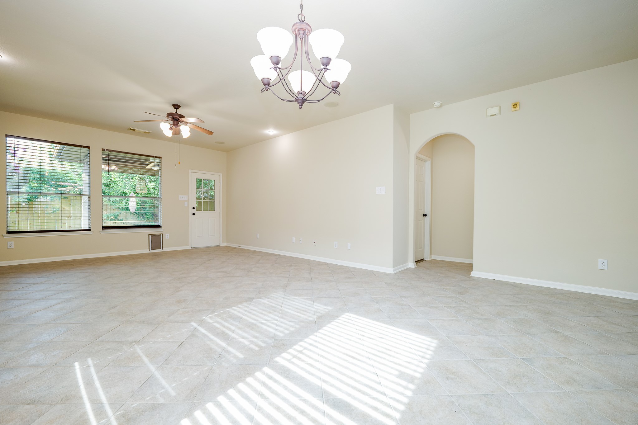 20127 Jasper Oaks Drive Cypress, TX 77433 - Photo 8 of 32 a view of a chandelier fan and windows