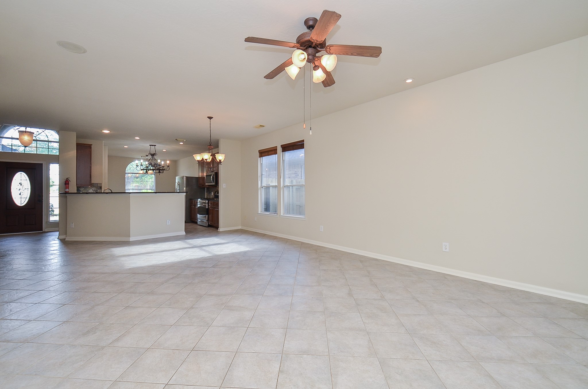 20127 Jasper Oaks Drive Cypress, TX 77433 - Photo 9 of 32 a view of a kitchen with a sink and a chandelier fan