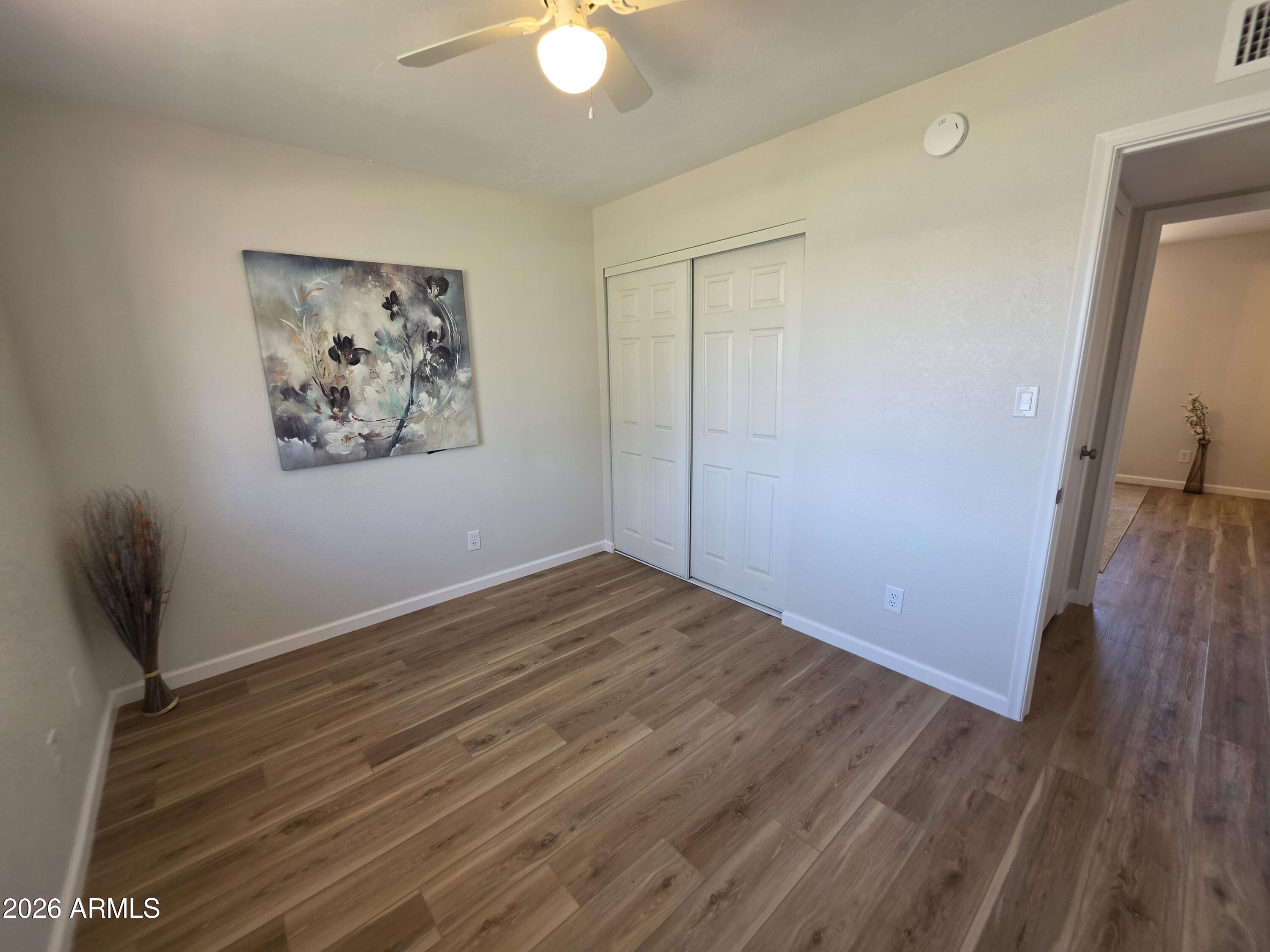46 East McLellan Road Mesa, AZ 85201 - Photo 14 of 18 an empty room with wooden floor and window
