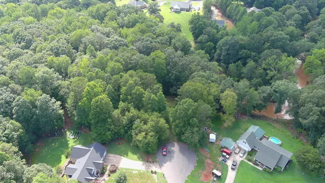 an aerial view of a house with yard swimming pool and outdoor seating