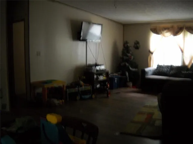 a living room with furniture and a lamp