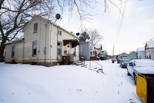 a view of a house with a snow in the yard