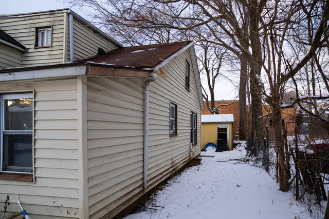 a view of a house with a yard covered in snow
