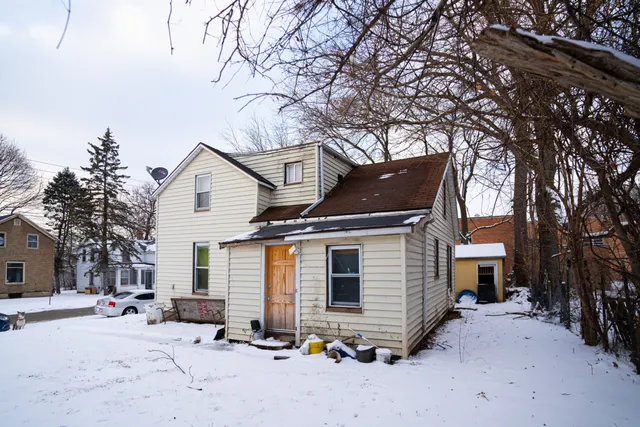 a view of a house with a snow on the road