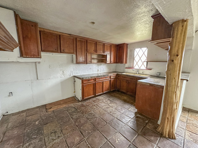 620 Sundown Road Caldwell, TX 77836 - Photo 8 of 15 a kitchen with stainless steel appliances granite countertop a sink stove and refrigerator