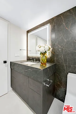 a large bedroom with a bed and large window