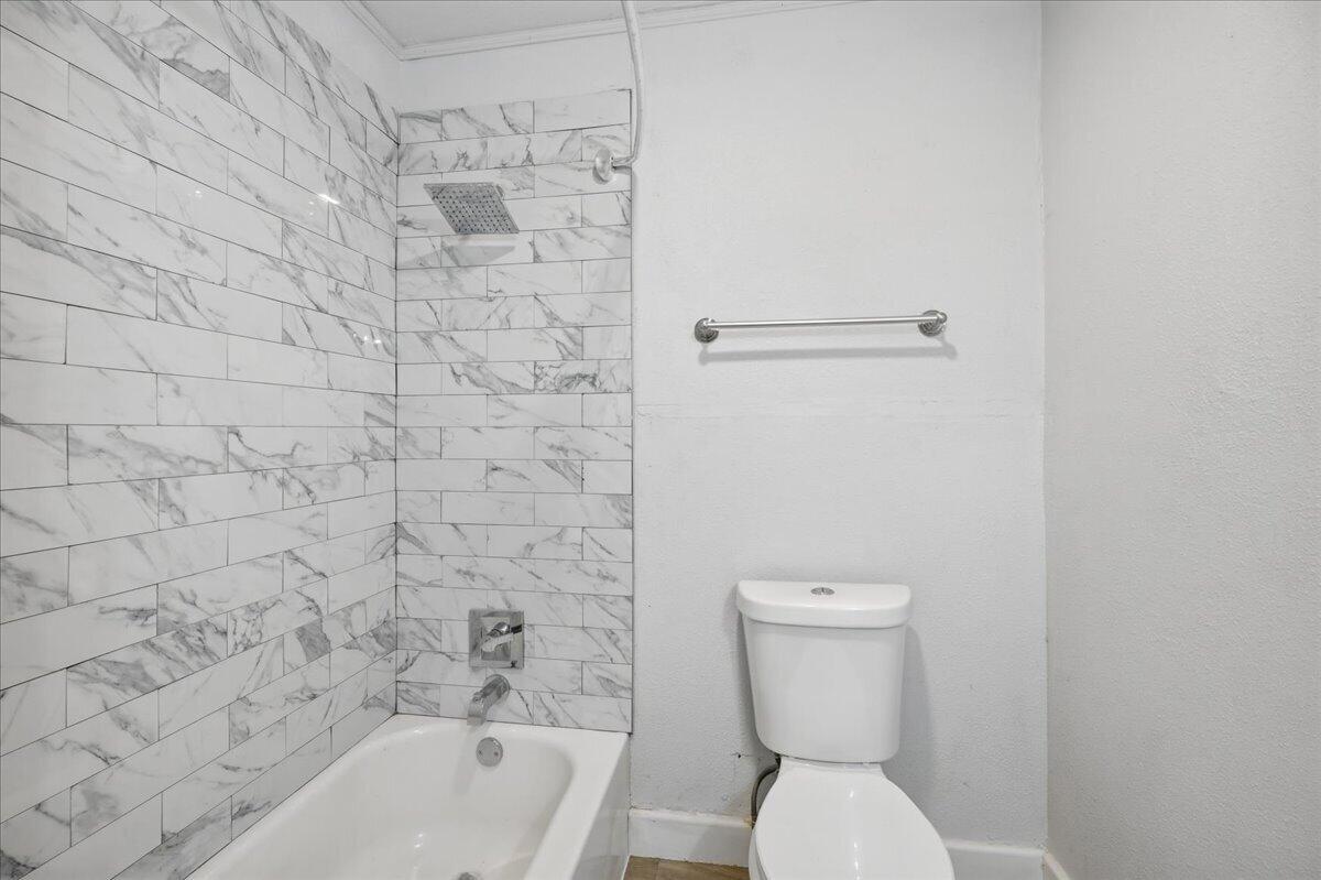 2503 30th Street Lubbock, TX 79410 - Photo 16 of 26 a bathroom with a toilet and a shower