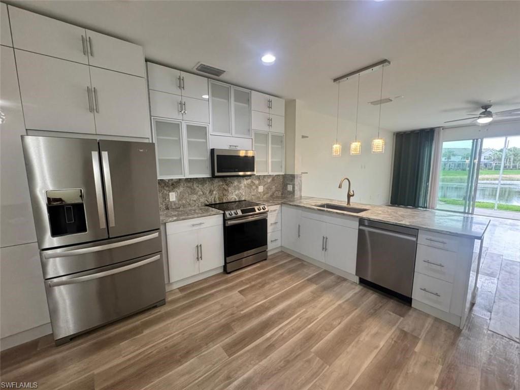 a kitchen with a refrigerator stove and sink