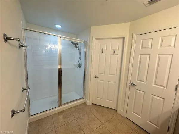 a spacious bathroom with a granite countertop sink a mirror and a vanity