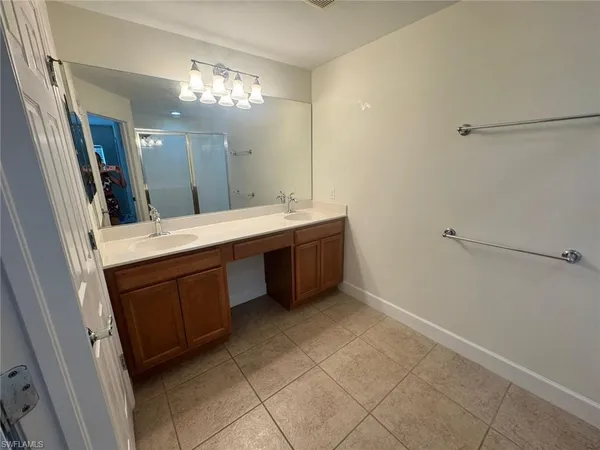 a bathroom with a double vanity sink mirror and toilet