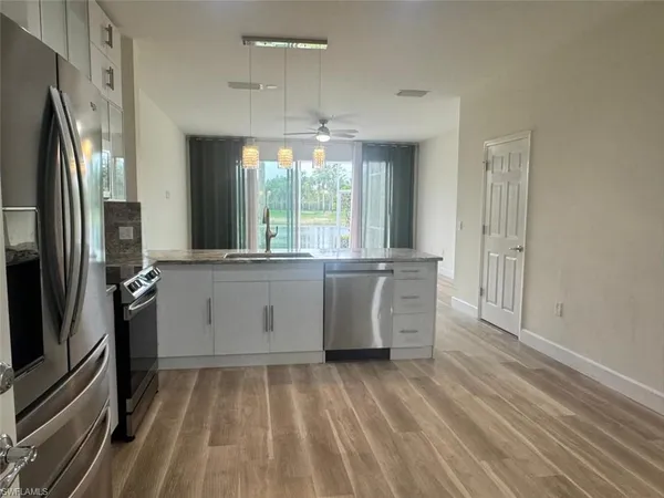 a kitchen with stainless steel appliances a sink stove and refrigerator