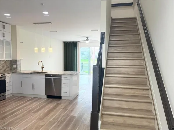 a view of a kitchen with sink and cabinets