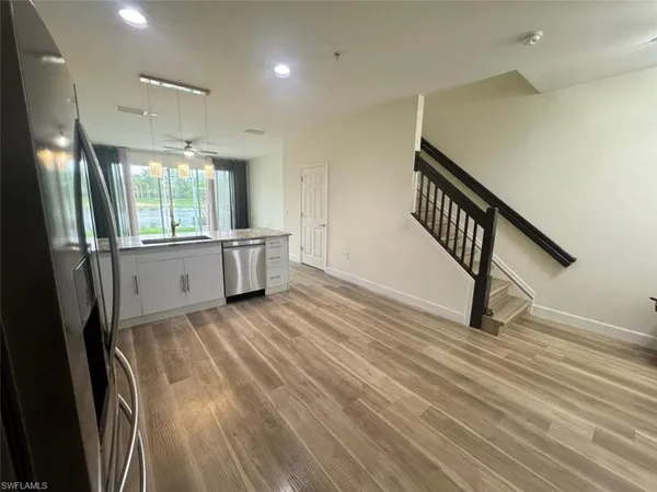 an empty room with wooden floor and a window