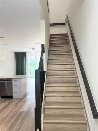 a view of entryway and hall with wooden floor