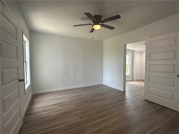 wooden floor in an empty room with a window