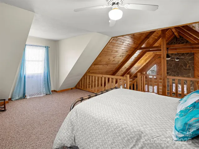 a view of a livingroom with wooden floor and stairs