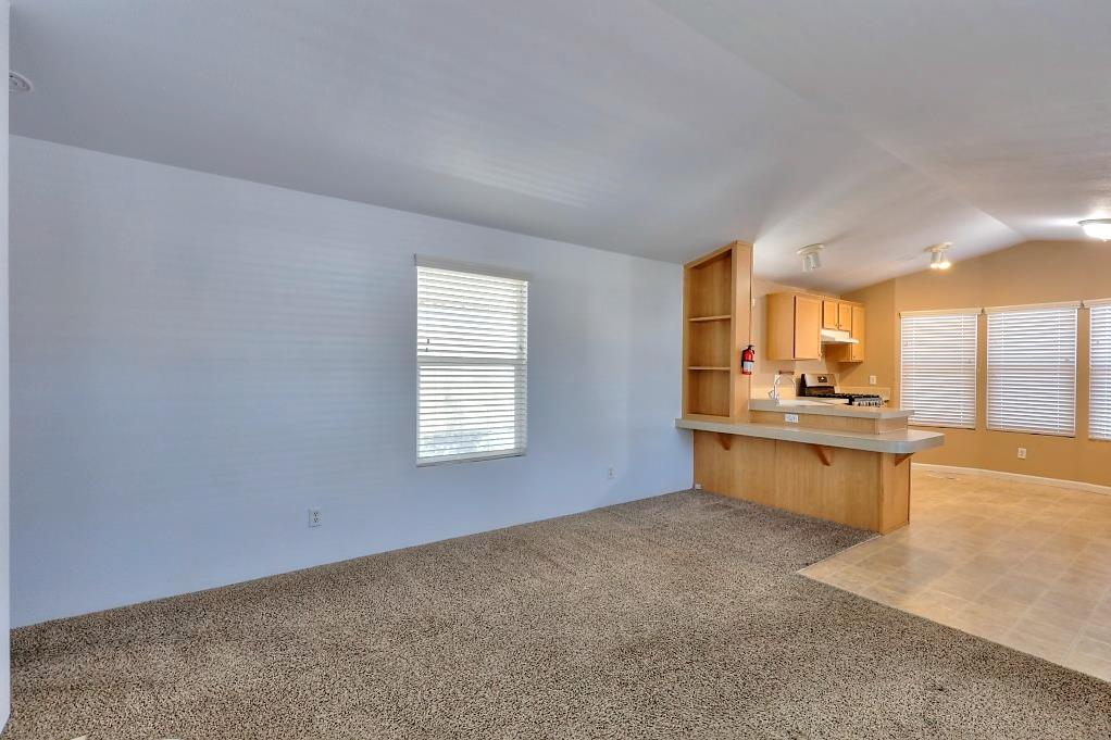 3506 Homestead Way Ceres, CA 95307 - Photo 10 of 39 a large white kitchen with granite countertop a sink white cabinets and a dishwasher