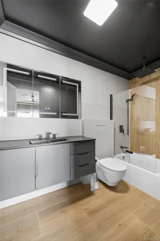 a bathroom with a double vanity sink toilet and shower
