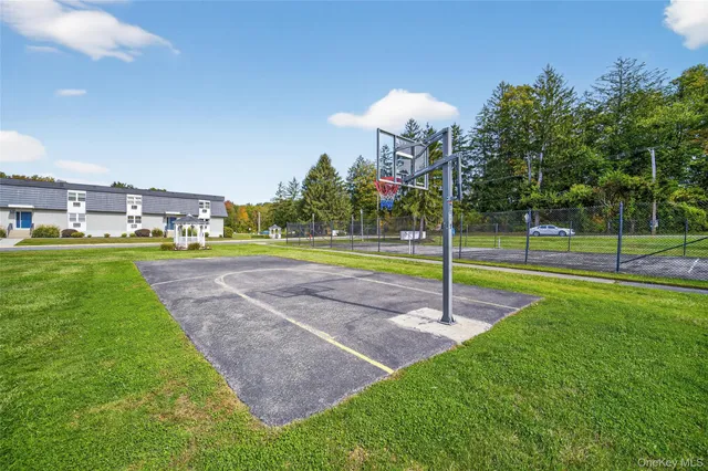 a view of a house with cars parked on the road
