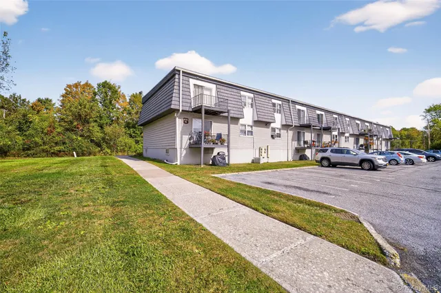 a view of a park with swings and a palm tree