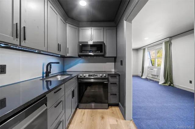 a kitchen with granite countertop a stove and a sink