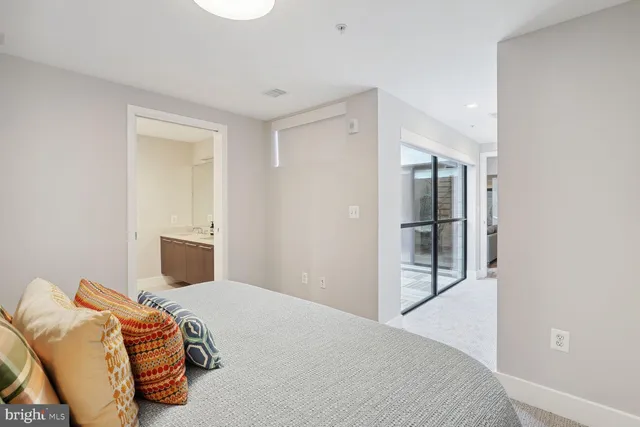 a bedroom with a bed and painting on the wall