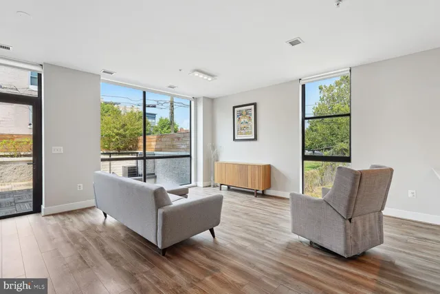 a living room with furniture and a large window
