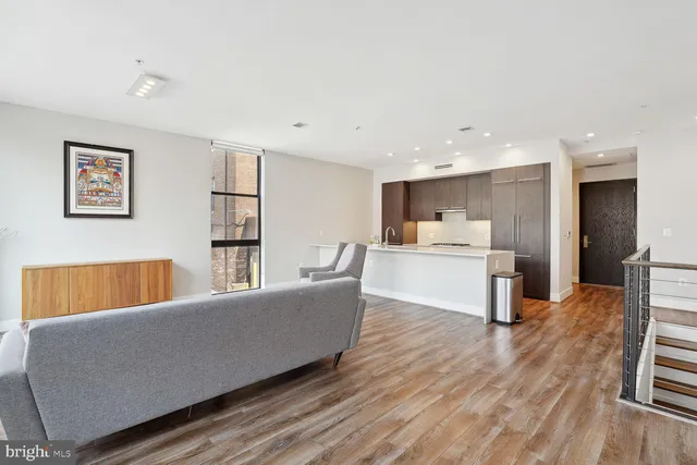 a living room with furniture and kitchen view