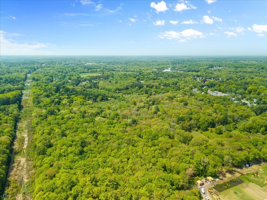 548 R Berkley Street Berkley, MA 02779 - Photo 8 of 12 a view of a green field with lots of bushes