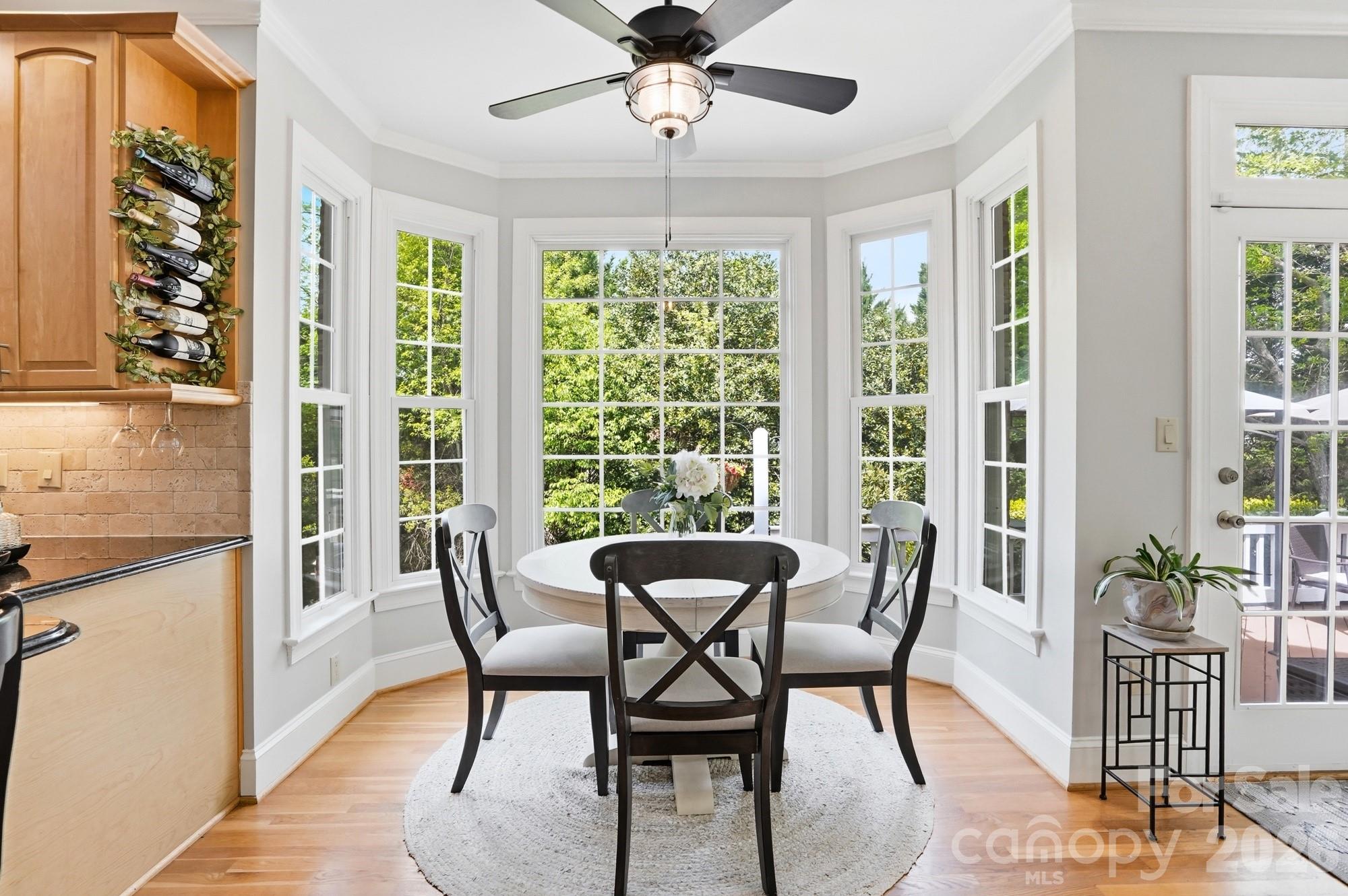 11078 Deep Cove Drive Tega Cay, SC 29708 - Photo 15 of 46 a view of a dining room with furniture window and wooden floor