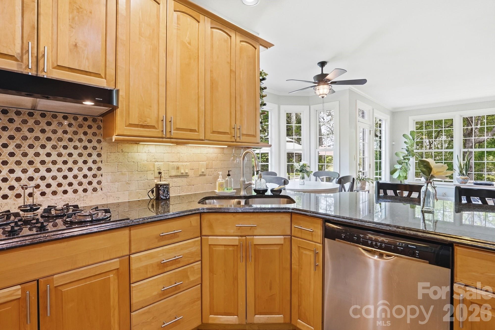 11078 Deep Cove Drive Tega Cay, SC 29708 - Photo 18 of 46 a kitchen with stainless steel appliances granite countertop a sink a stove and cabinets
