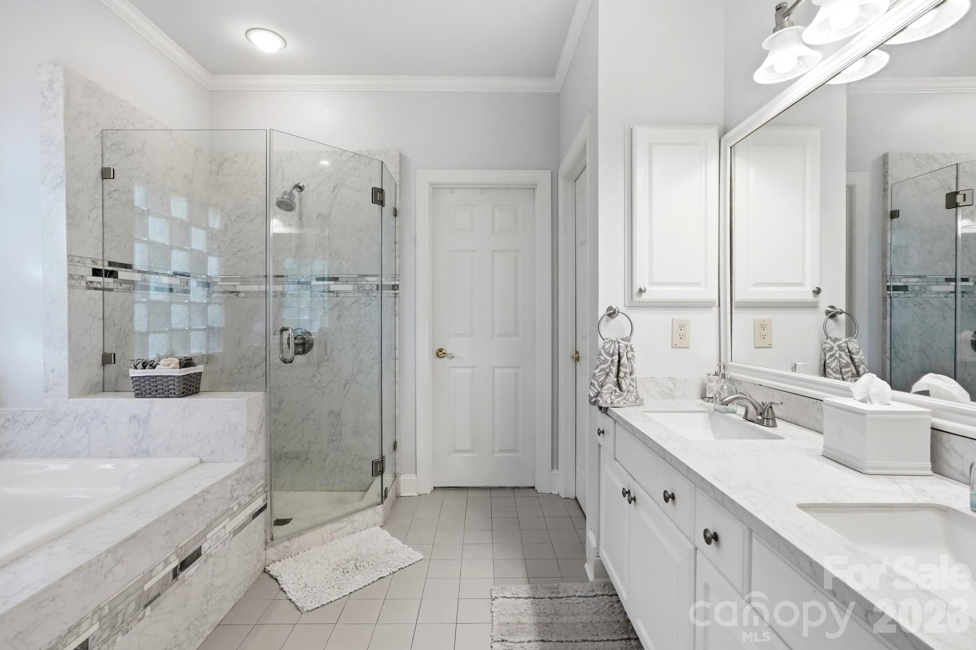 11078 Deep Cove Drive Tega Cay, SC 29708 - Photo 22 of 46 a bathroom with a double vanity sink toilet mirror and bathtub