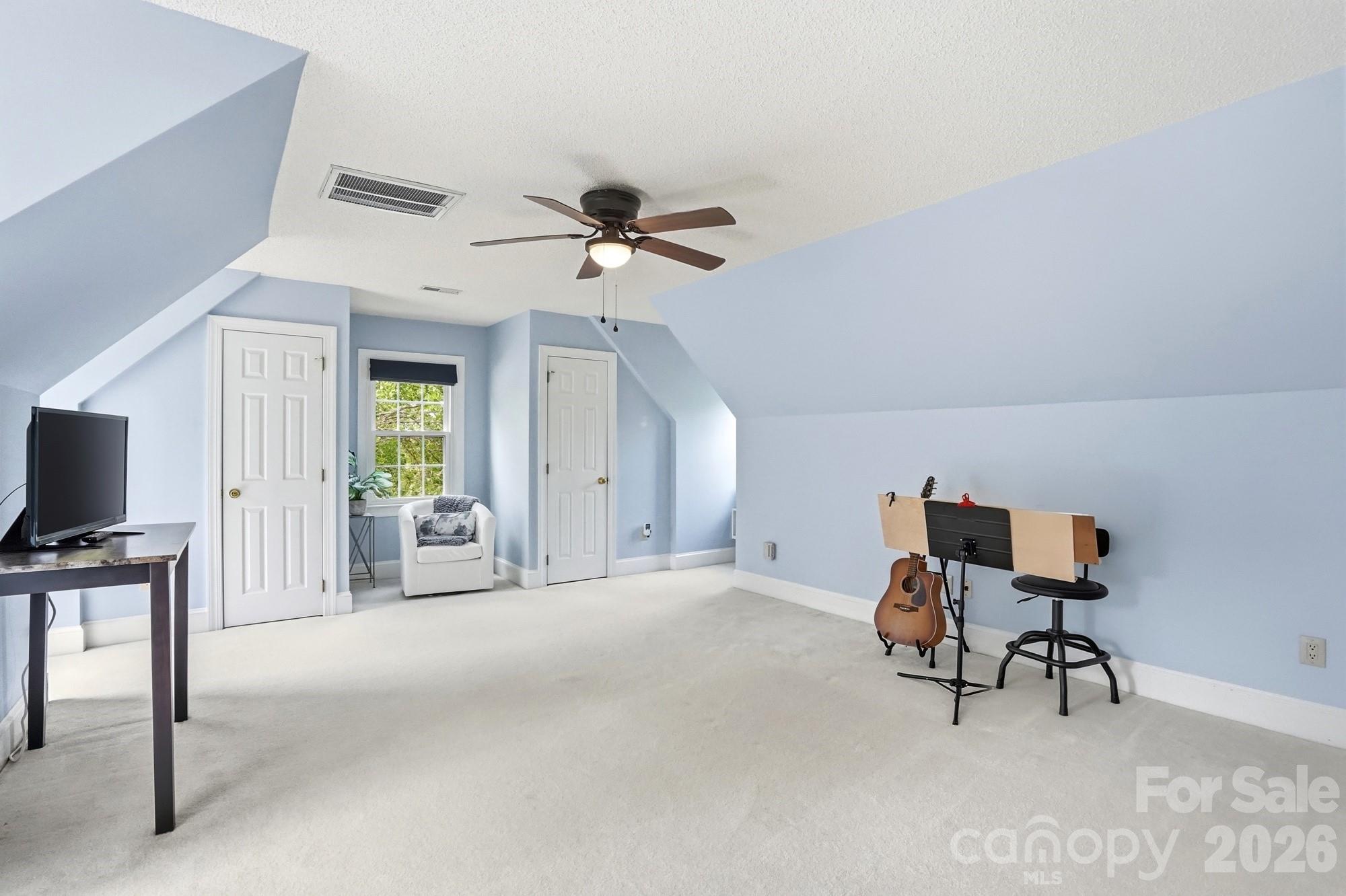 11078 Deep Cove Drive Tega Cay, SC 29708 - Photo 25 of 46 a view of a livingroom with a flat screen tv and a ceiling fan