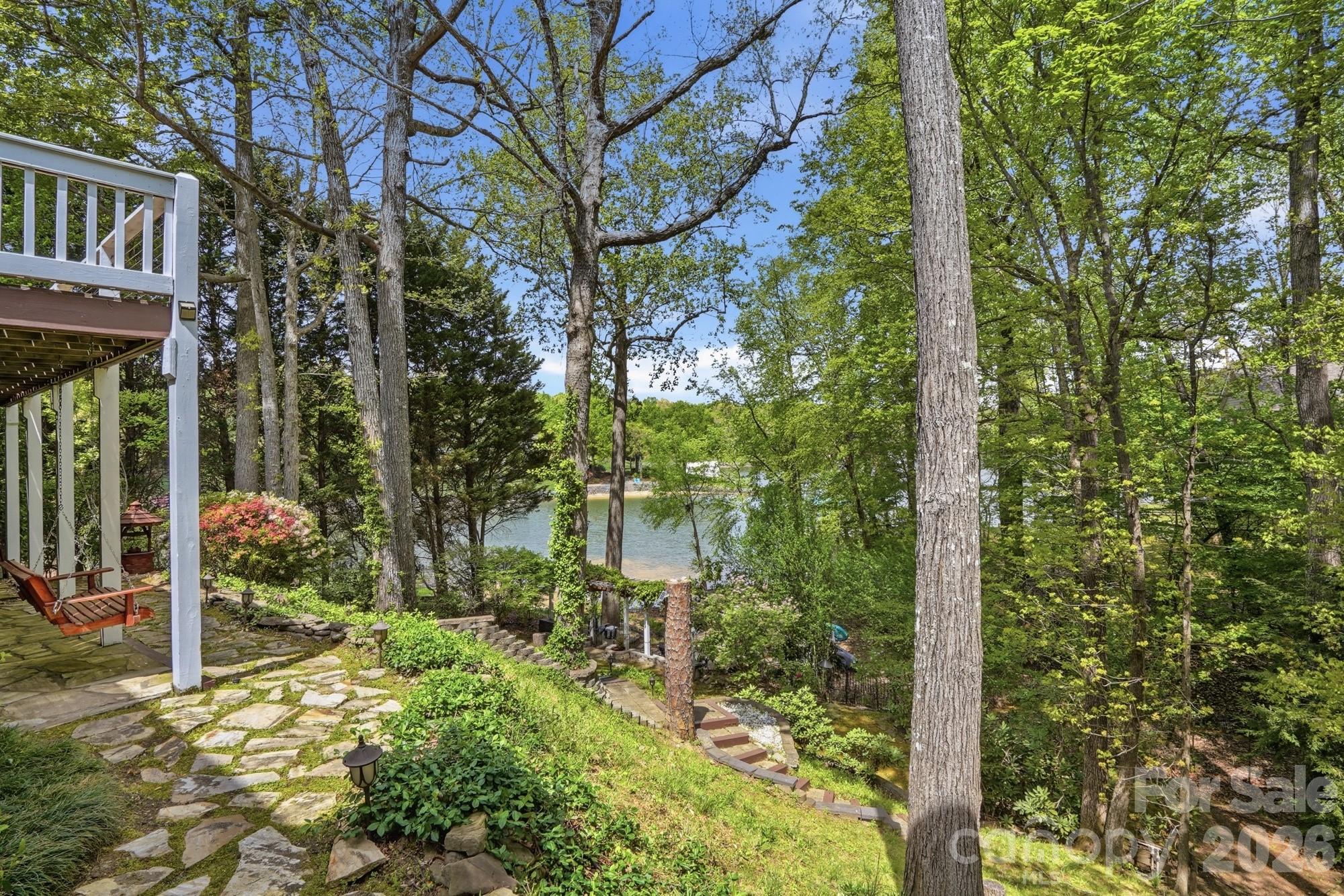 11078 Deep Cove Drive Tega Cay, SC 29708 - Photo 39 of 46 a backyard of a house with lots of green space and fountain