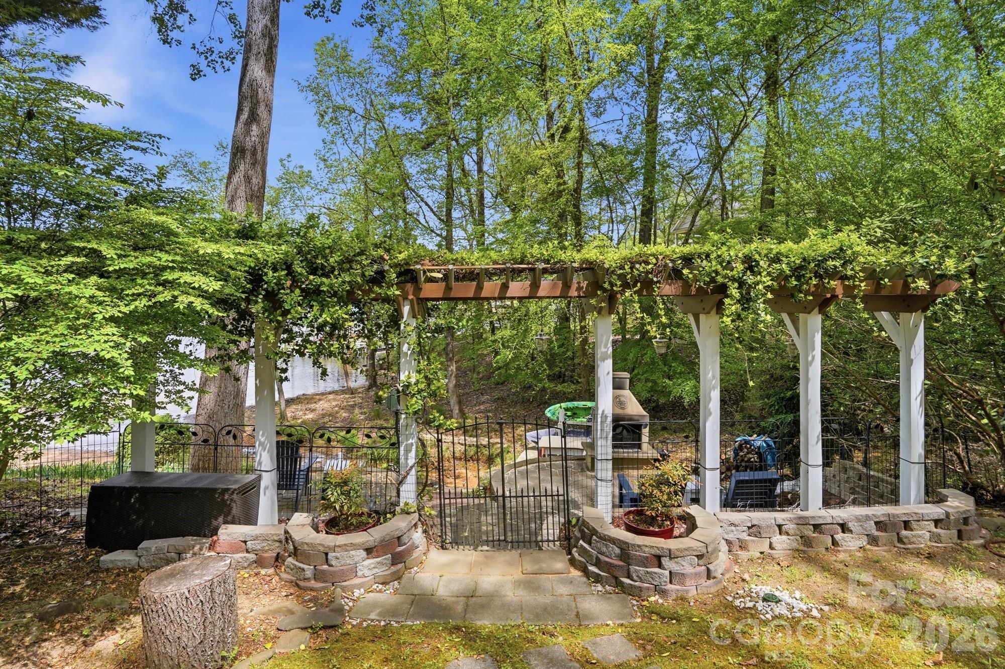 11078 Deep Cove Drive Tega Cay, SC 29708 - Photo 41 of 46 a view of a patio with table and chairs potted plants and large tree