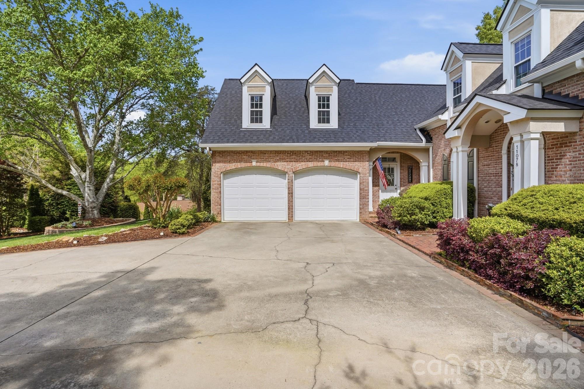 11078 Deep Cove Drive Tega Cay, SC 29708 - Photo 5 of 46 a front view of a house with a yard and garage
